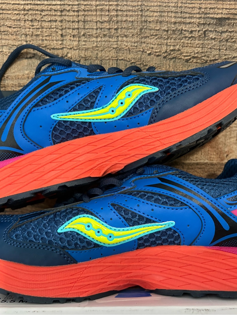 Saucony Blue running shoes with Neon Yellow-Green Logo and Coral Soles